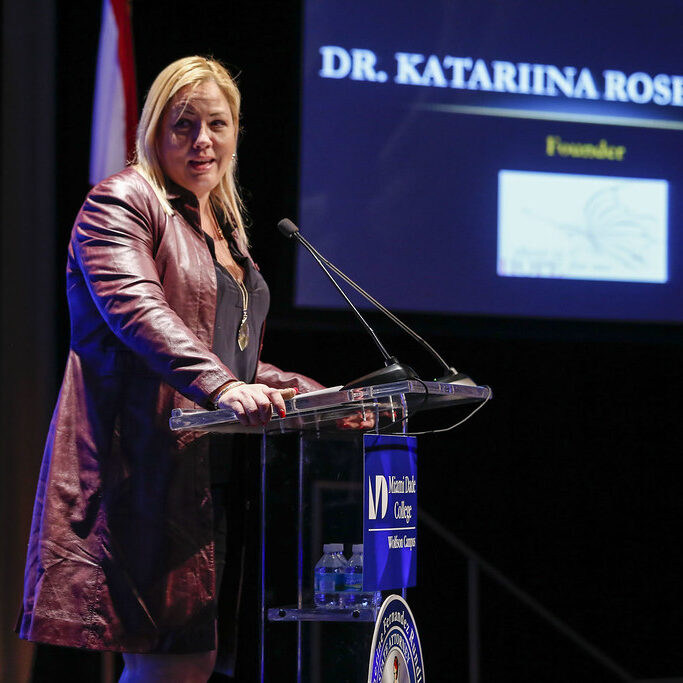 Dr. Kat Speaking at a Conference